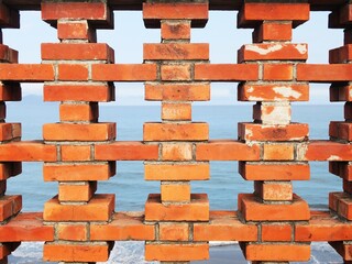 Obraz premium Orange red brick pattern in a watching tower near the sea