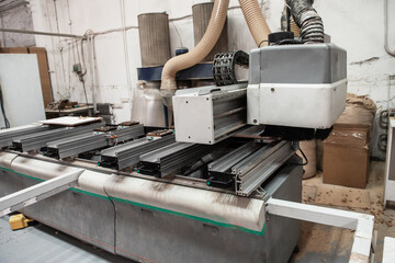 Wooden furniture production. Industrial machine for automatic wood drilling the mounting holes