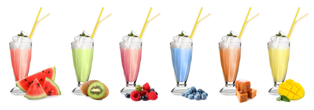 Glasses of different tasty milkshakes on white background