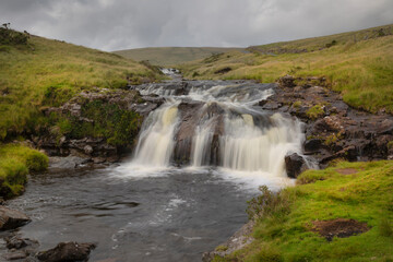 Fototapeta na wymiar A waterfall on the river Tawe in its early stages in the Brecon Beacons, South Wales UK 