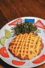 crisby chicken lime sauce on white dish