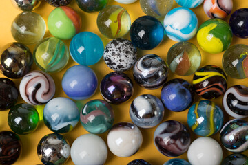 Colorful Marble Balls on Yellow background. Abstract Pattern