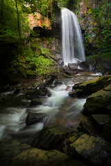 Fototapeta premium The moody and beautiful tall waterfall in Resolven, near Neath, South Wales, UK