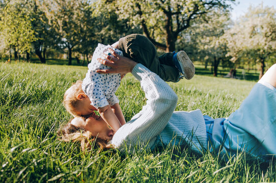 Kiss and hugs of mom and son. Mom and son walk in the summer park. Happiness to be a mom. Happy mother's day. 