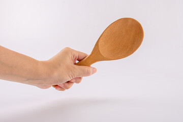 Woman hand with wooden spoon isolated on white background