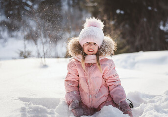 little girl playing with snow