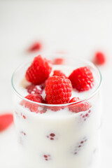 Milk with raspberry in the glass. Selective focus. Shallow depth of field.