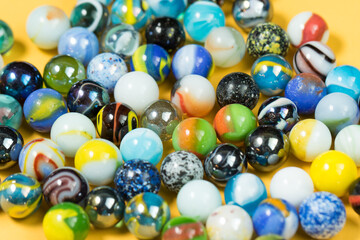 Fototapeta na wymiar Colorful Marble Balls on Yellow background. Abstract Pattern