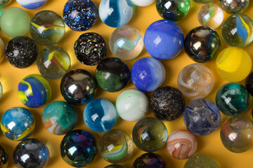 Colorful Marble Balls on Yellow background. Abstract Pattern