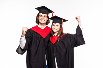 Young Couple in graduation gowns holding diplomas and celebrate isolated on white background