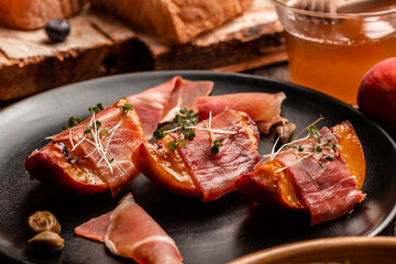 appetizer with grilled peach, ham and dor blue cheese capers, microgreen, Delicious breakfast or snack