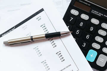 calculator and pen on financial documents