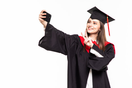 Young female graduated student taking selfie isolated on white background