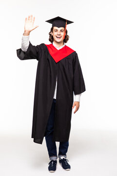 Graduate man student in mantle greets with his hand, isolated on white background