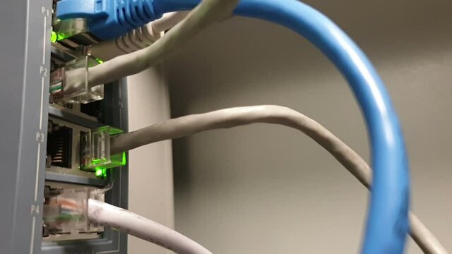 Concept on the topic of information transfer over an optical fiber network.Cables connected to a professional router through which there is a high-speed data transfer
