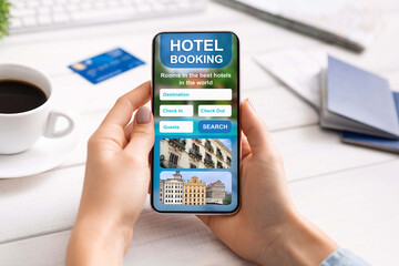 Closeup of smartphone with hotel booking app in female hands
