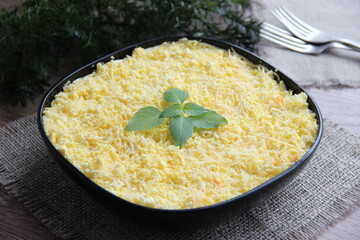 Mimosa salad in a black plate