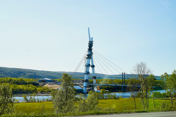 Obraz premium View on railing of bridge and water of river below. Hills in nature landscape in the evening or during the day. Concept of travel and tourism.