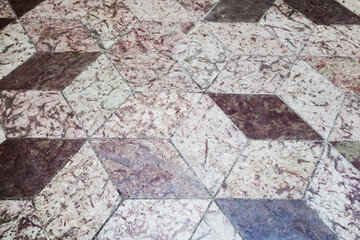Old floor tiling with abstract cubic pattern