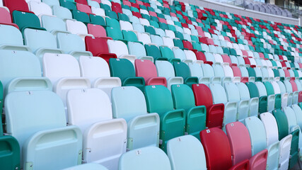 Obraz premium Multicolored seats in a sports stadium. The seats for the fans