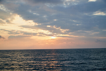 Water of sea and sky with clouds and sunset.