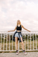 Young slim fit woman standing on a bridge with a view.