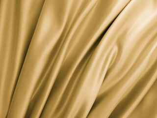 Beautiful smooth elegant wavy golden yellow satin silk. Luxury cloth fabric texture, abstract background design. Copy space. 