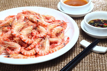 A Plate Of Steamed Shrimp With Two Sauce