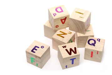 Educational wooden building blocks, cubes with alphabet letters isolated on white background