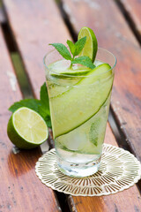 Refreshing drink - water with cucumber slices, ice cubes and fresh mint leaves.