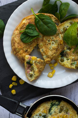 An omelette with sweet corn, green peas and spinach.