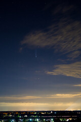 Comet neowise C2020 F3 in the night starry sky over the city and church