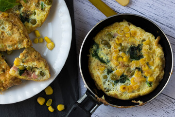 An omelette with sweet corn, green peas and spinach.