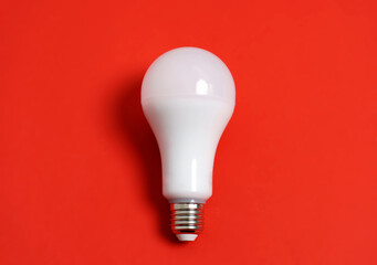 Energy saving lamp on a red background