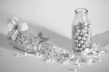 White beads pouring out of a glass bottle