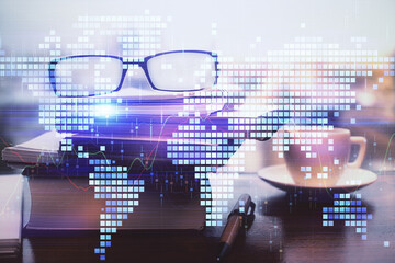 Business theme hologram with glasses on the table background. Concept of search. Double exposure.