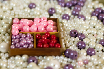 Multicolored pearl beads in a wooden box