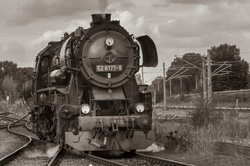 Naklejka premium Steam Locomotive, german Steam Locomotive, Steam Locomotive and big Clouds in Background, black and white photo
