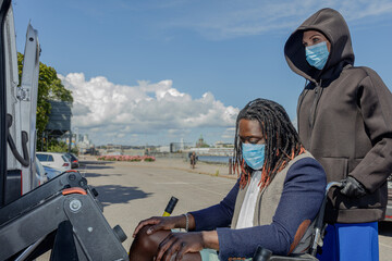 A young African man wears a medical mask to protect himself from the coronavirus outbreak. Close-up...