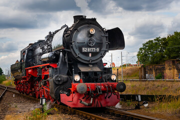 Fototapeta na wymiar Steam Locomotive, german Steam Locomotive, Steam Locomotive and big Clouds in Background
