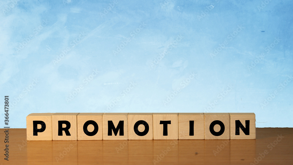 Poster promotion message word on a wooden desk on cube blocks