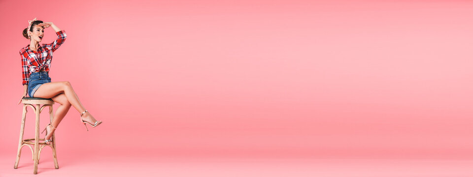 Full length portrait of a smiling brunette pin-up girl