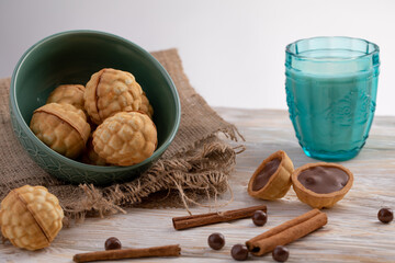 chocolate chip cookies and glass of milk in background. baking nuts with chocolate and cinnamon