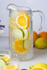 Water with fresh orange, lemon and lime slices.