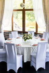 Festive table setting with wine glasses, and fresh flowers