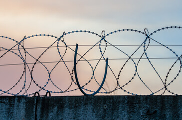 barbed wire on a concrete fence