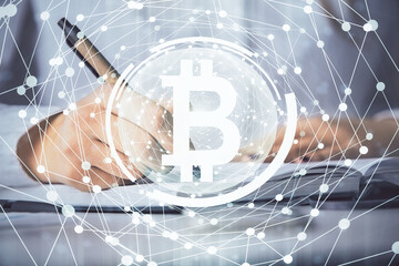 Cryptocurrency hologram over woman's hands writing background. Concept of blockchain. Double exposure
