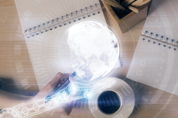 Multi exposure of hands making notes with world map hologram and data theme icons. Concept of global data.