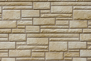 Wall with decorative tiles in the form of beige brickwork