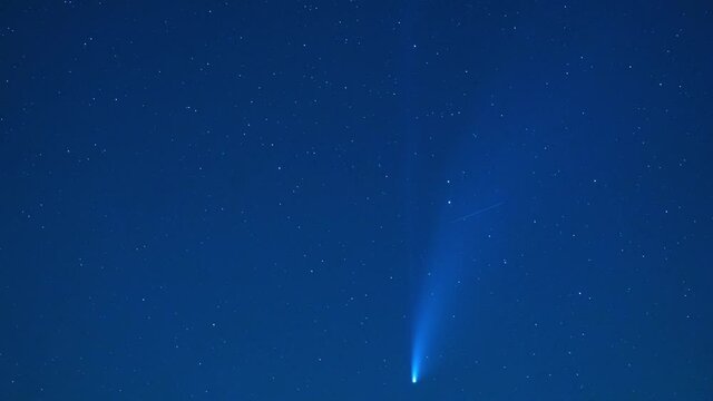 Comet Neowise timelapse. Stock video of shooting star shining in a starry blue night sky. Meteorite. Stardust.